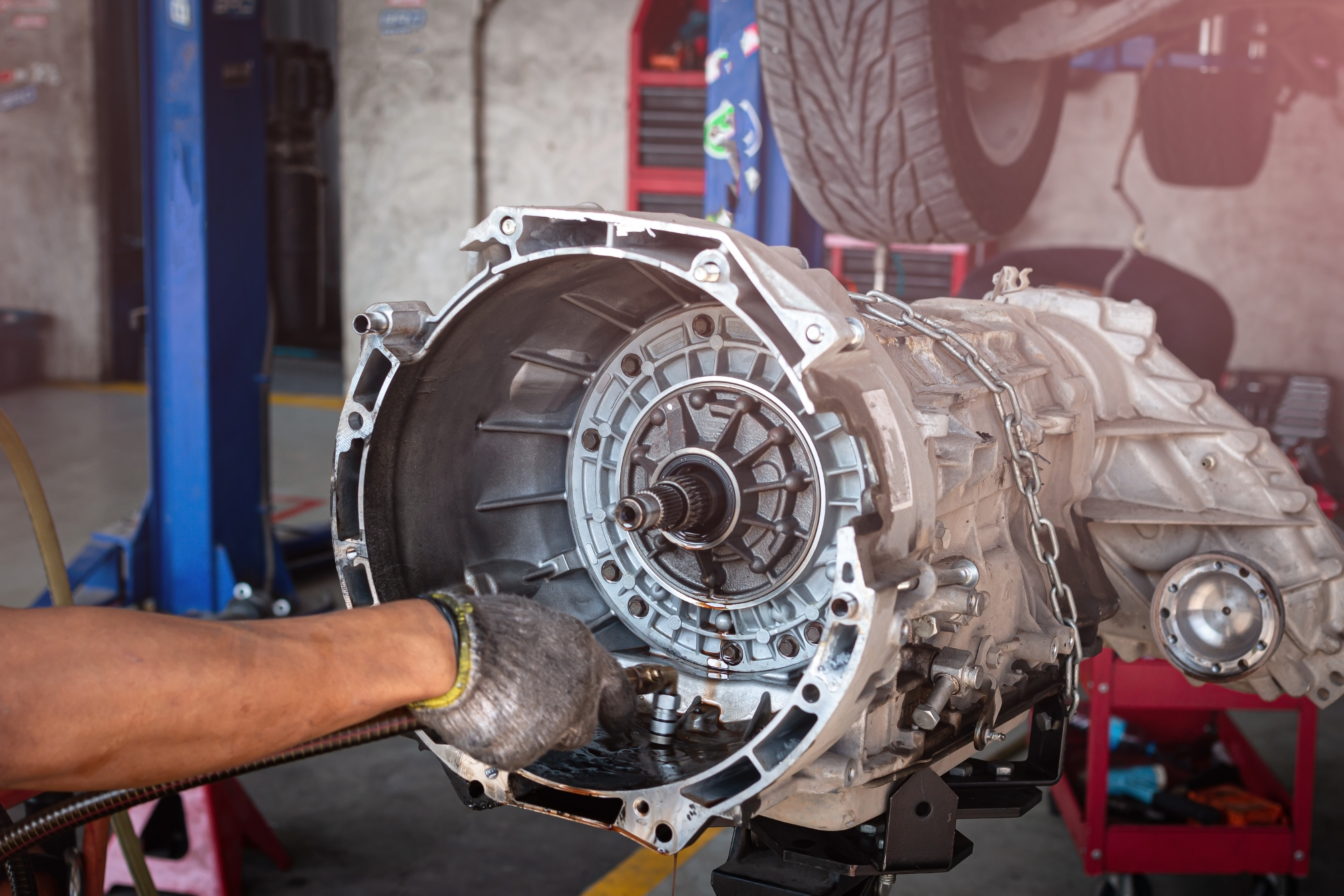 Mechanic removing transmission for full rebuild